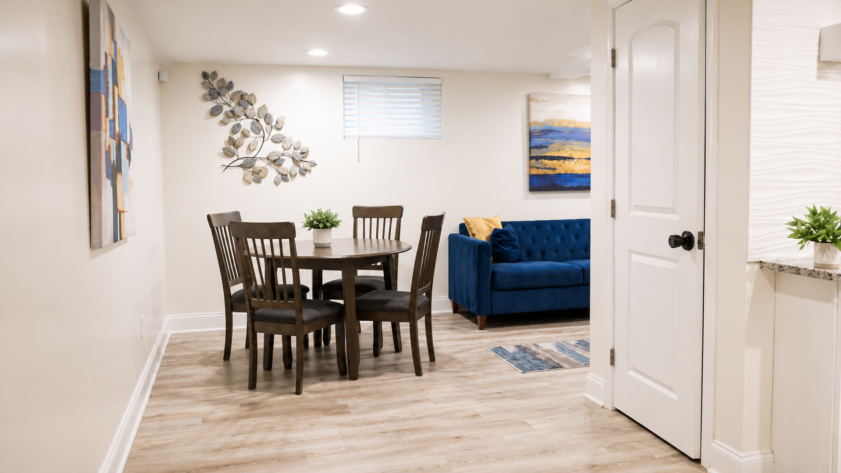 Dining area with blue sofa in the common space